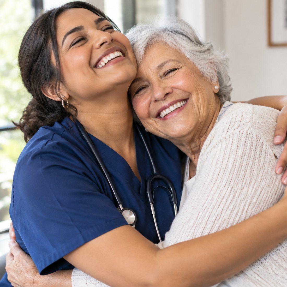 A nurse in scrubs embracing a smiling older woman in her living room